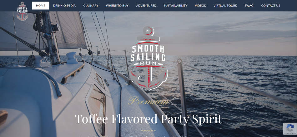 smooth sailing rum website screen shot: a sail boat on the water at sunset